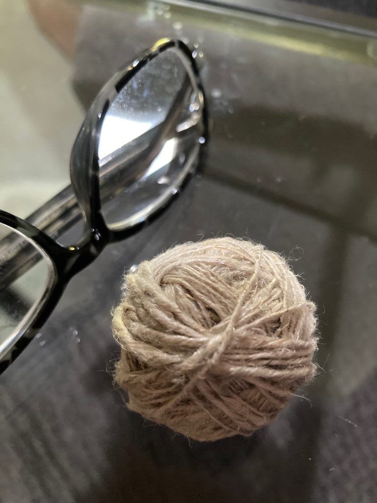 Photo of a ball of string I made from flax I harvested, it represents my fiber related topics in Blog Hub.