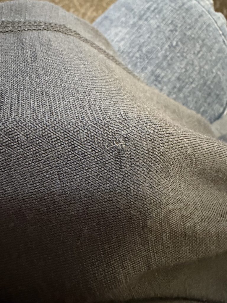 Photo of a small hole that has been mended. 