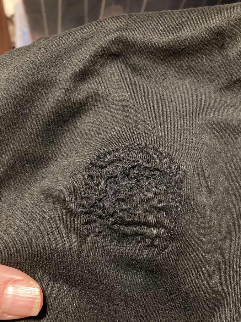 Running tights with a patched hole seen from the outside. 