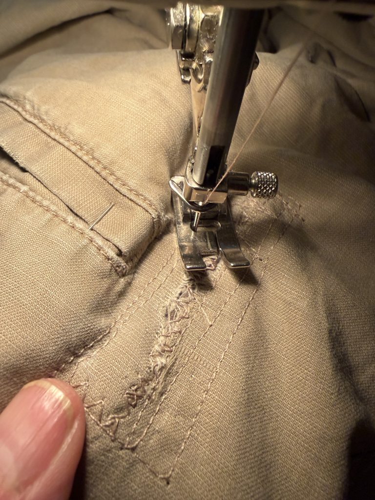 Stitching up the hole in the back of the shorts.