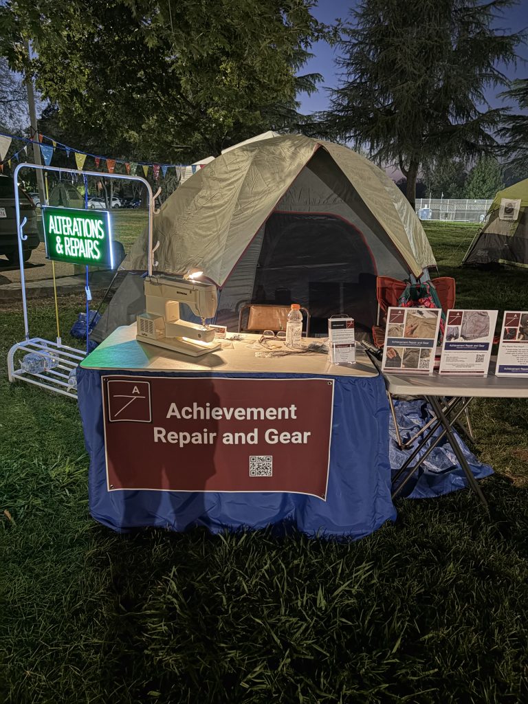 My set up at the Mile Madness race in 2026, includes tent, table, sign and sewing machine