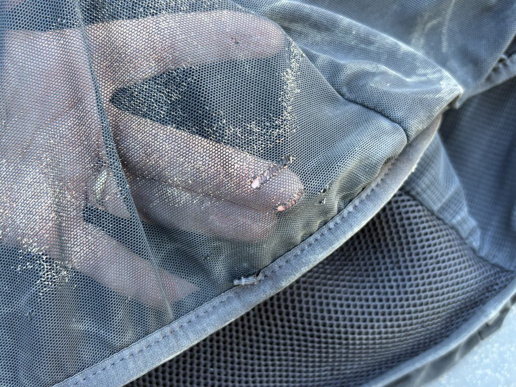 Worn-Out mesh on a hydration pack that has holes in it. 
